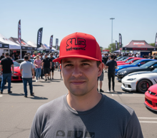 Load image into Gallery viewer, man wearing SLB_classic_red_snapback at car show 
