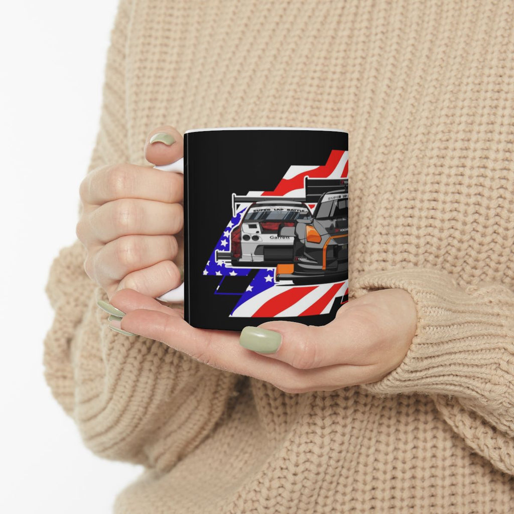 Person holding a mug with a car design featuring American flag colors.